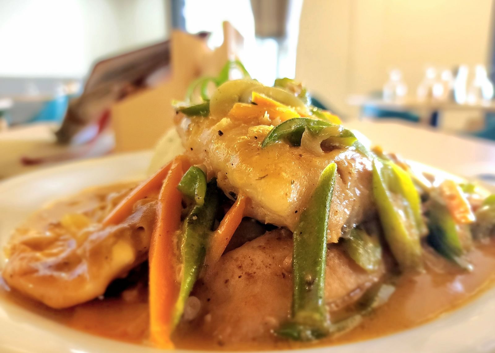 A close-up of a gourmet dish with vibrant vegetables and sauce - Hotel 39, Jamaica