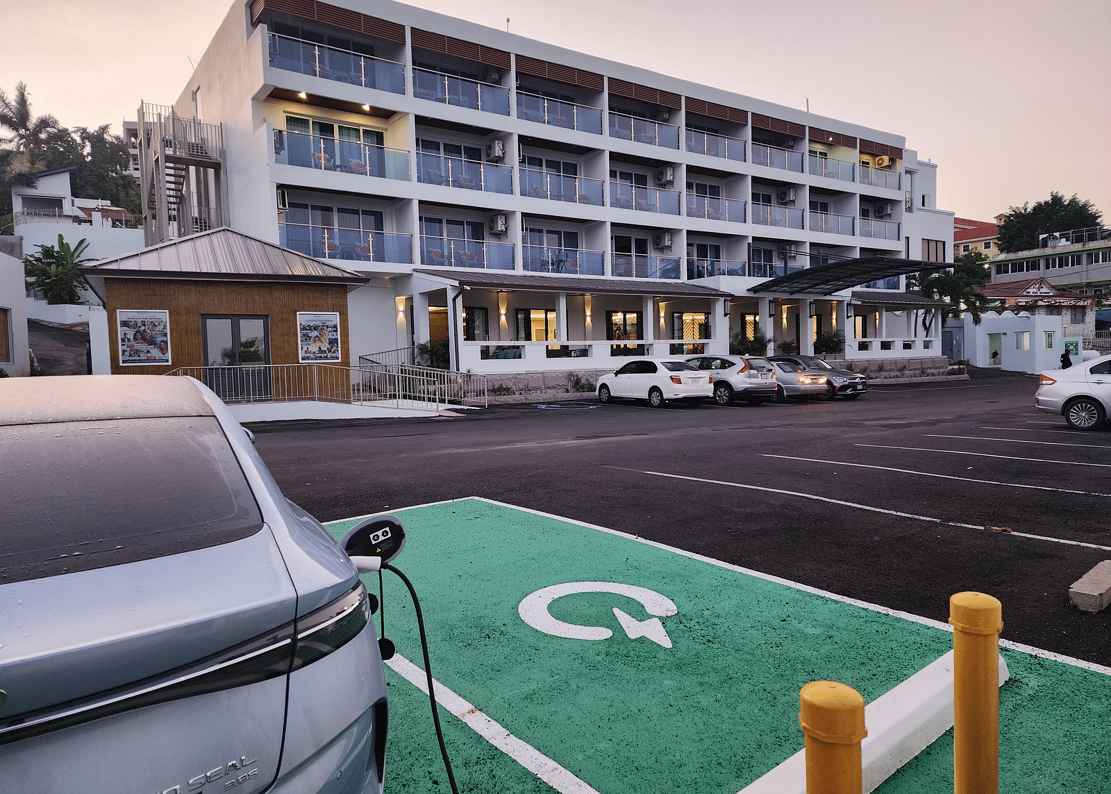 A hotel exterior with an electric car charging station in the parking lot - Hotel 39, Jamaica