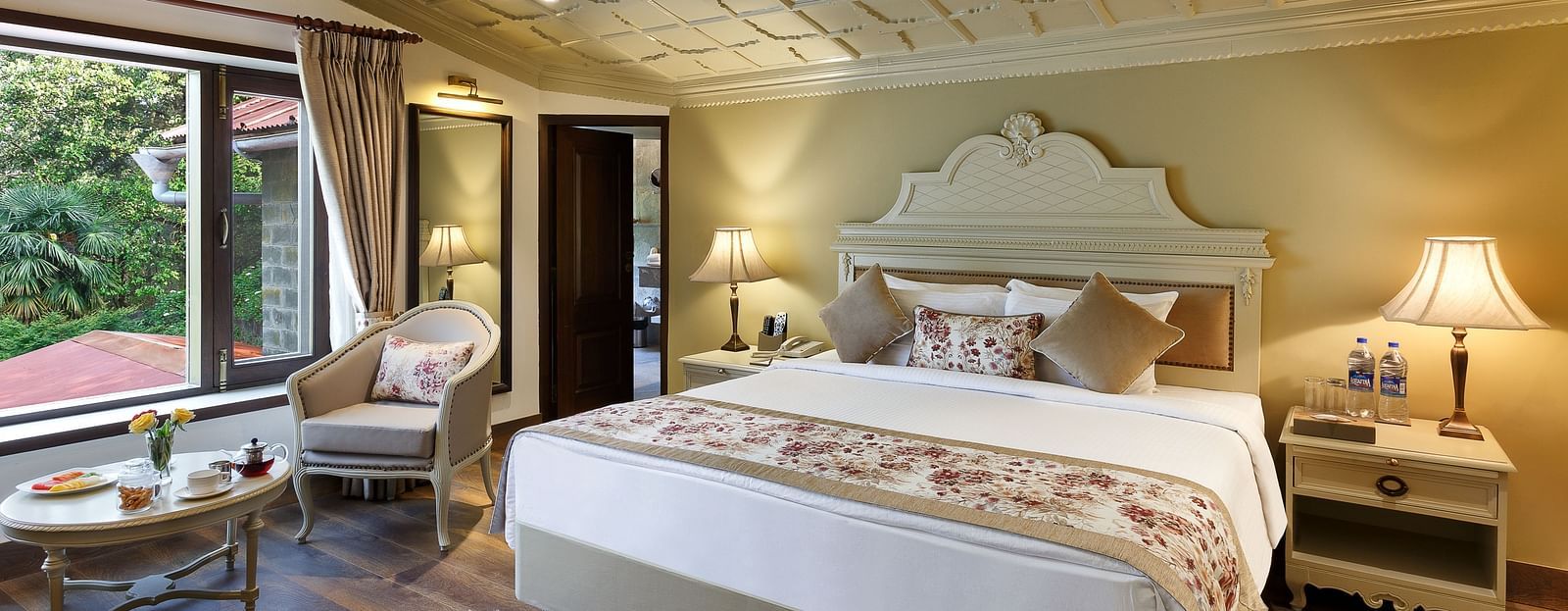 Luxurious hotel room with a four-poster bed.