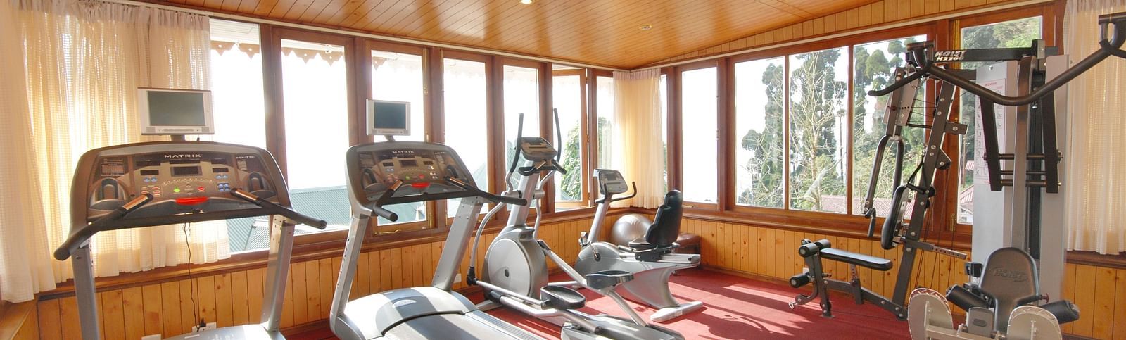 treadmill and other equipment in the gym - Mayfair Hill Resort, Darjeeling 