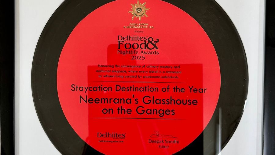 Framed award plaque for 'Staycation Destination of the Year 2025' awarded to Neemrana's Glasshouse on the Ganges by Delhiites Food & Nightlife Awards.