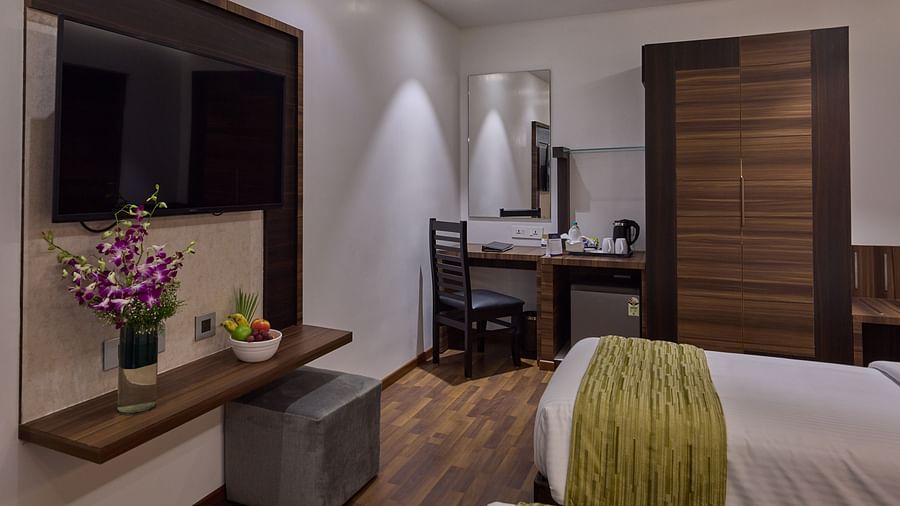 Another view of twin beds with a study table inside executive rooms at Grand Continent - A Sarovar Premiere Affiliate Hotel, Hosur