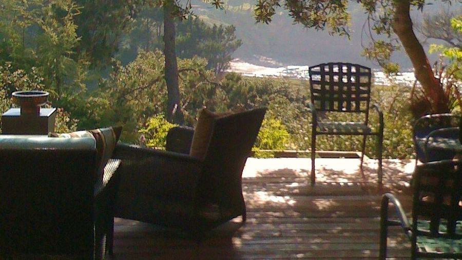 A shaded deck overlooking rolling hills - Brewery Gulch Inn & Spa