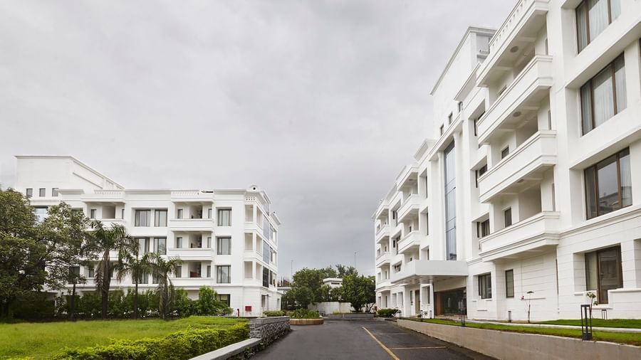 Another perspective of the clean, white-and-glass facade of Monday Hotels Mahape, Navi Mumbai.