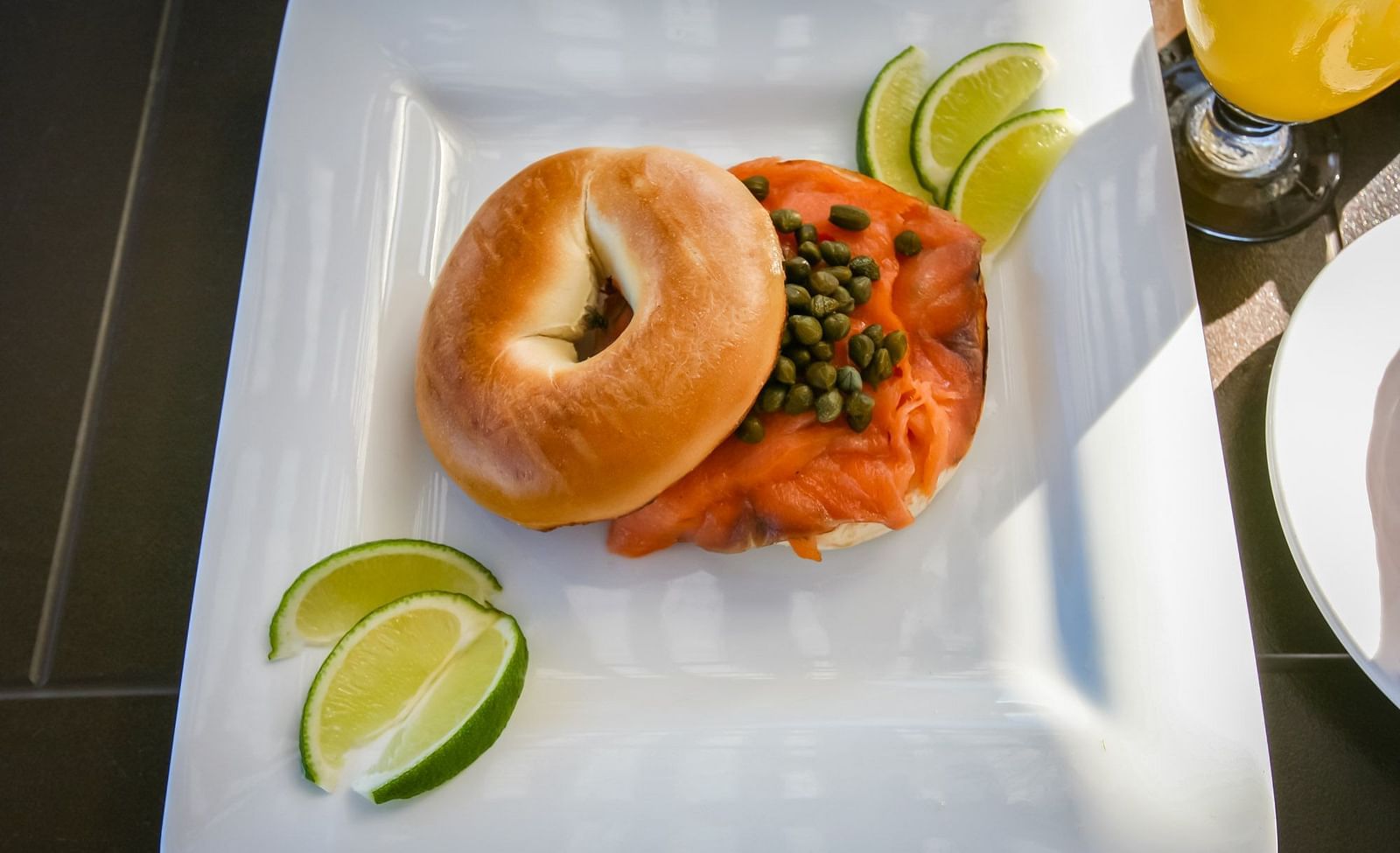 Close-up of bagel with lime wedges served on a plate | Abaco Inn