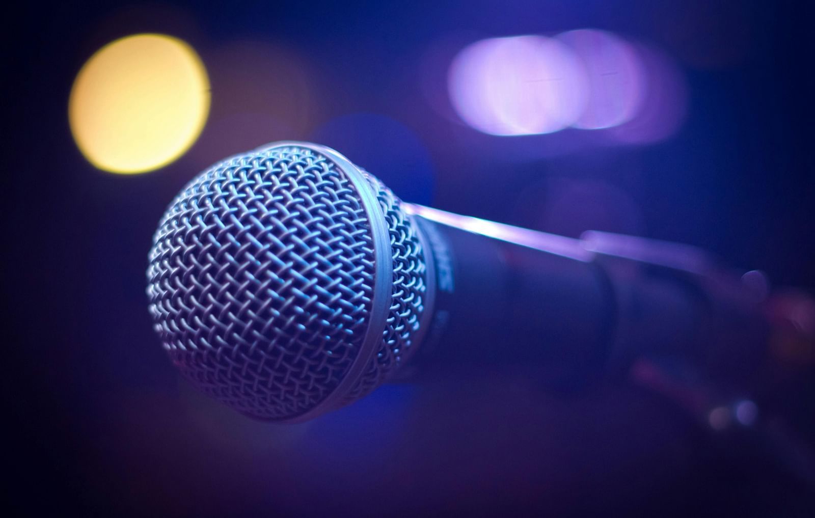A microphone surrounded by disco lights.
