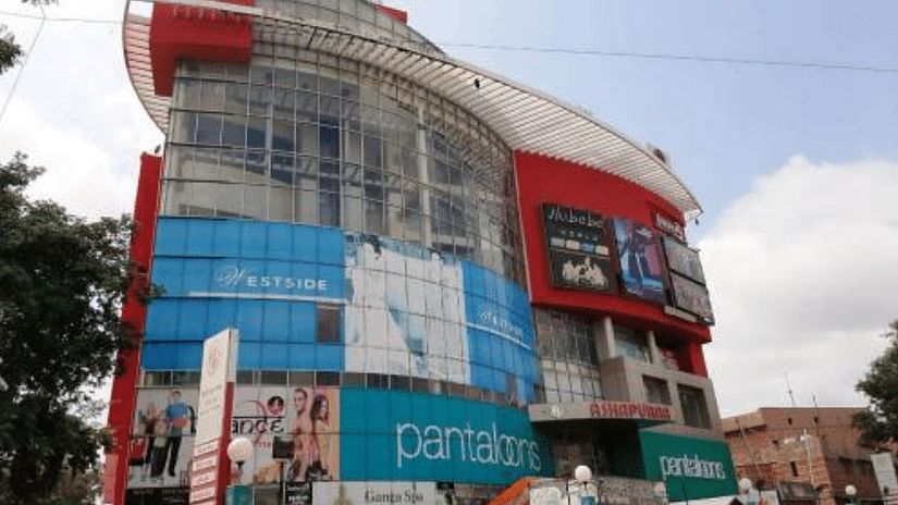 A side angle view of Blue City Mall, featuring a prominent advertising board that enhances the vibrant shopping atmosphere of the location.