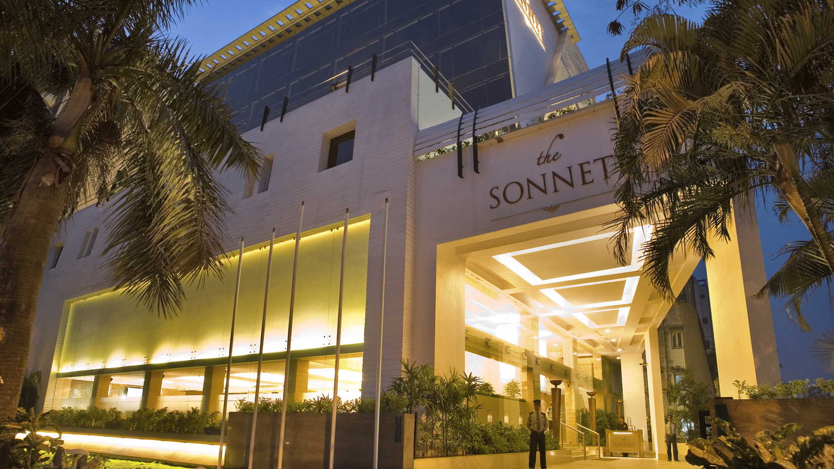 Exterior view of The Sonnet hotel building in the evening, well-lit with the hotel name prominently displayed.