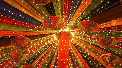 Close-up of vibrant overhead decorations at a festive Dandiya event.
