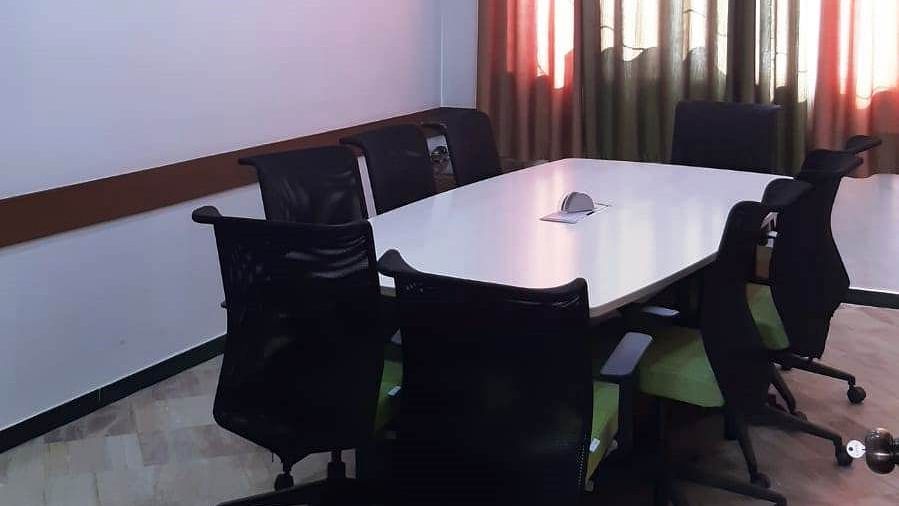 Air conditioned Board room with table and office chairs at Hotel Dr Rajkumar International.