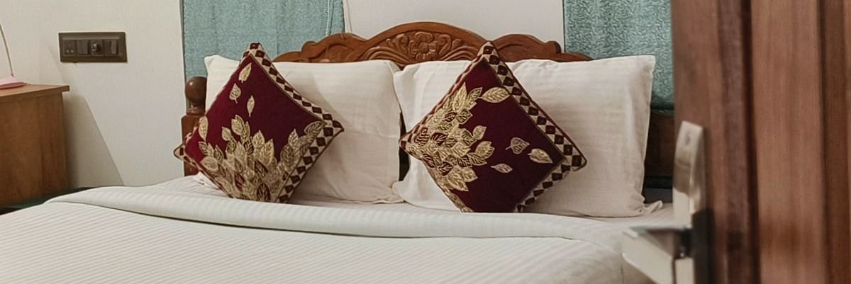 View of a double bed from the door of 104 room at Ananda Holiday Home, Wayanad 1