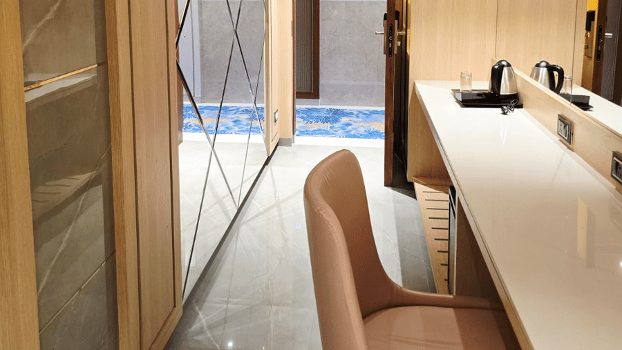 Contemporary room with wardrobe, desk, and mirror at Hotel Mumbai House Digha, Airoli.