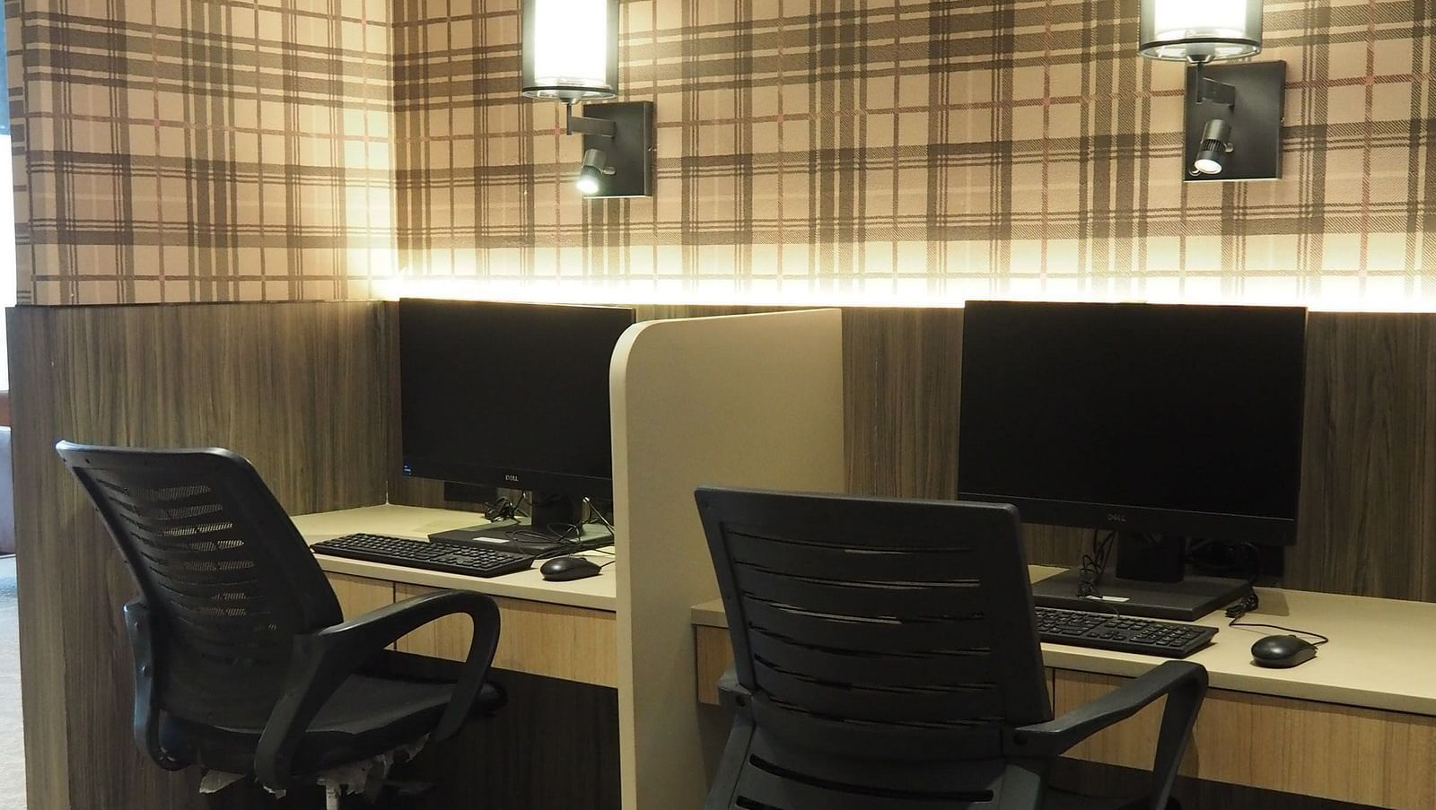 A small office space with two desks, chairs and a computer placed on the table - Club Charholi, Pune 