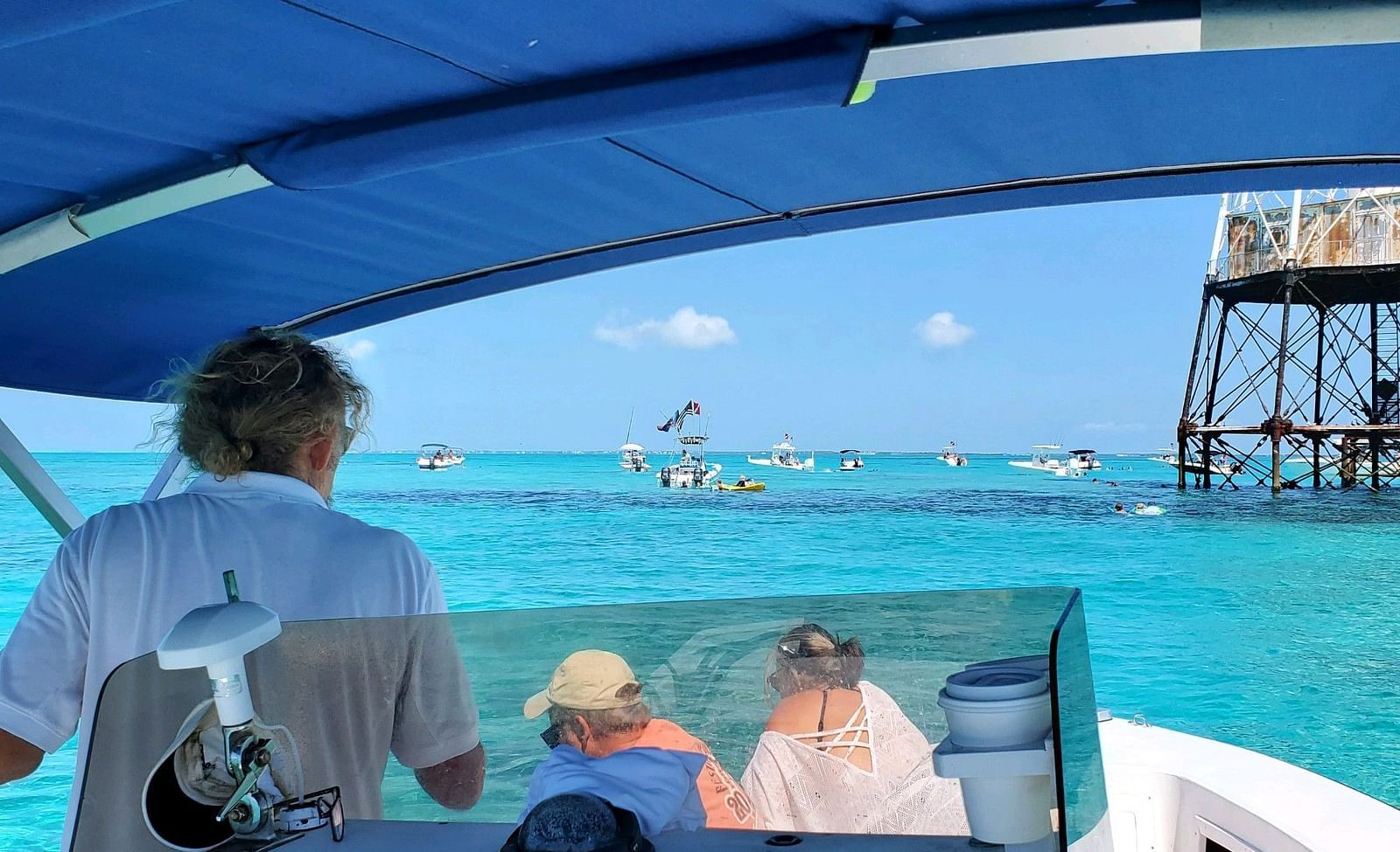 Guests onboard a boat ride with a canopy at Casa Morada, cruising through clear blue waters.