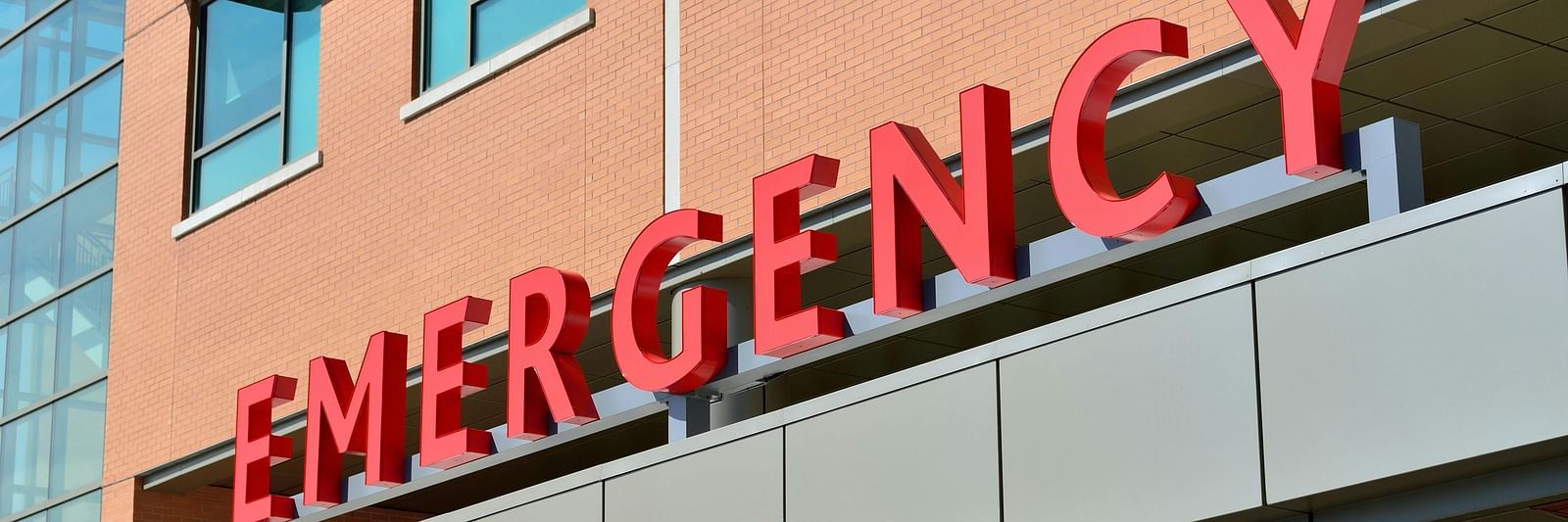 The word 'EMERGENCY' on the exterior of a building.