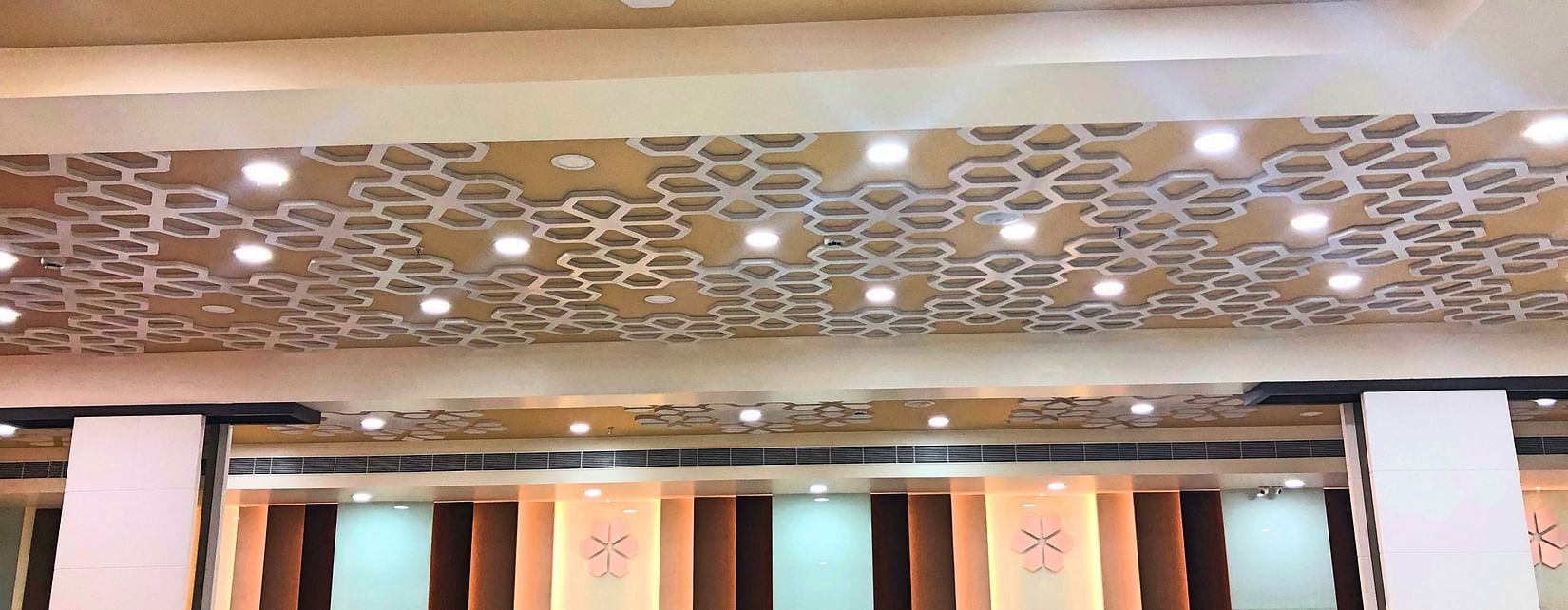 an empty Banquet Hall in Tirupati with many lights switched on - Raj Park Hotel, Tirupati