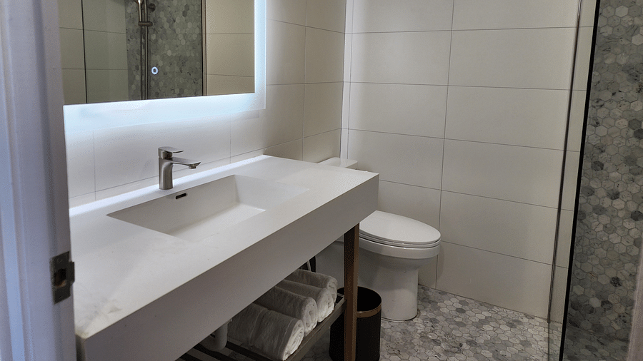 A minimalist bathroom with a large mirror and contemporary sink setup - Hotel 39, Jamaica