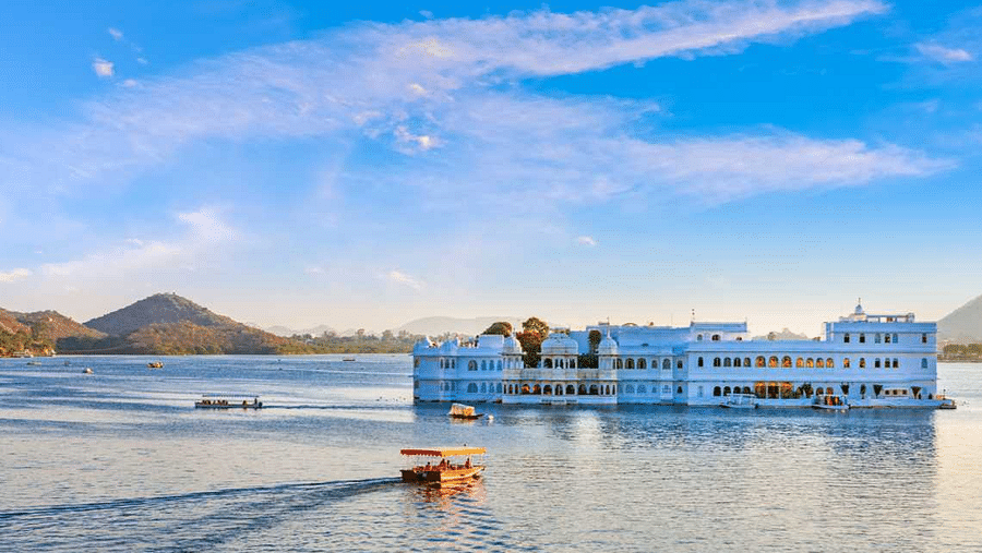 A floating palace inside a lake with a boat carrying passengers towards it