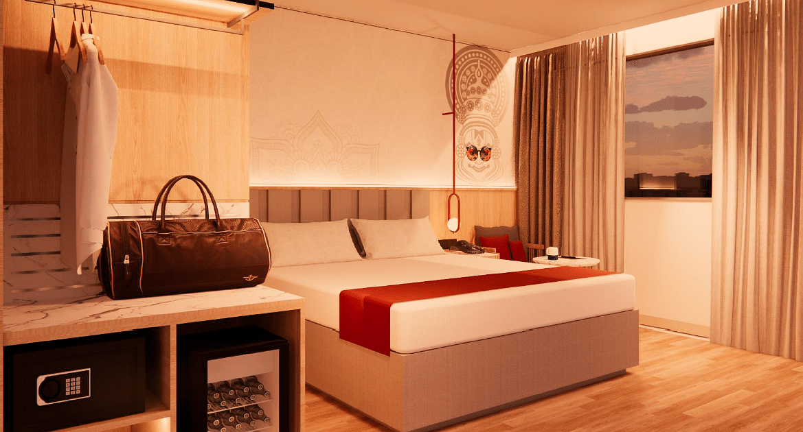 A close up shot of the plush bed in a room with warm lighting at TGI Oberon, Koramangala