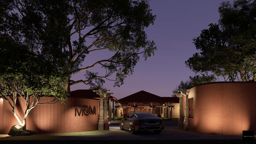 Render of a luxury estate entrance with 'MGM' signage, traditional stone pillars, and a car parked in the driveway under a large tree.