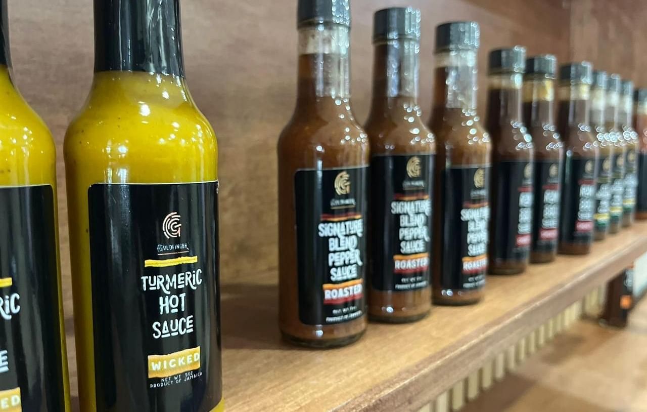 A collection of sauces sold placed on a rack at our gift shop in Montego Bay - Hotel 39, Jamaica