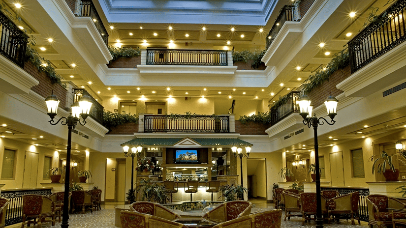  Atrium Coffee Shop, a restaurant in Sector 16, Noida, featuring elegant indoor seating, warm lighting, and a welcoming dining ambience.