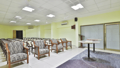 A conference hall with chairs facing the stage at VITS Select, Bharuch. One of the best wedding venues in Bharuch, Gujarat.