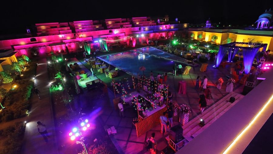 an aerial view of the pool deck decorated at night time - Buena Vista