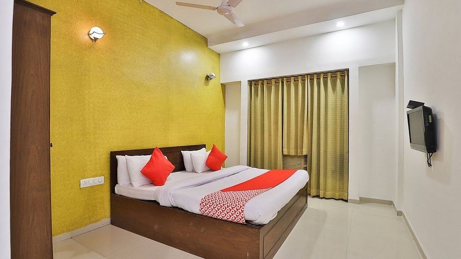Deluxe room with a large bed at VITS Select, Bharuch.