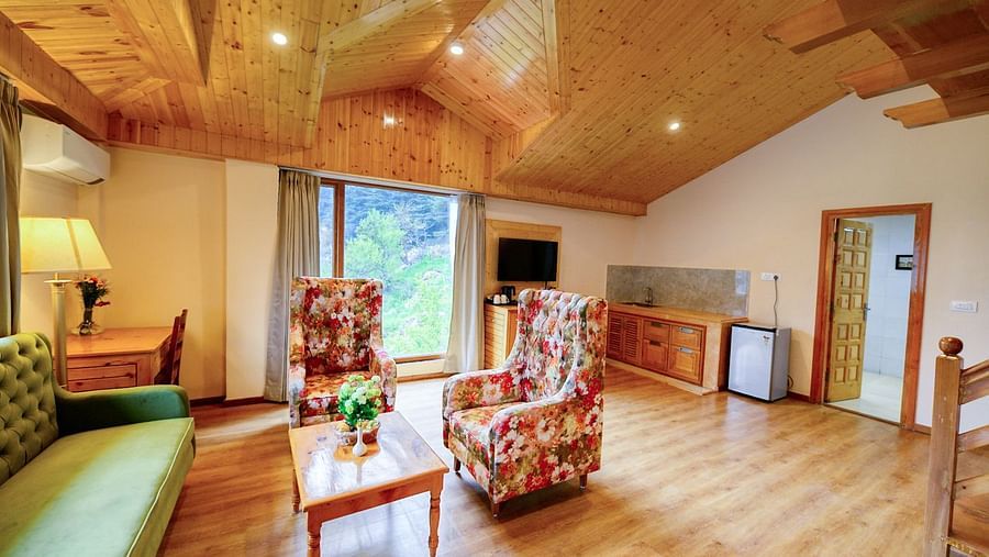 Well lit room with seating arrangement and wooden ceiling - Clarks Inn Suites, Manali