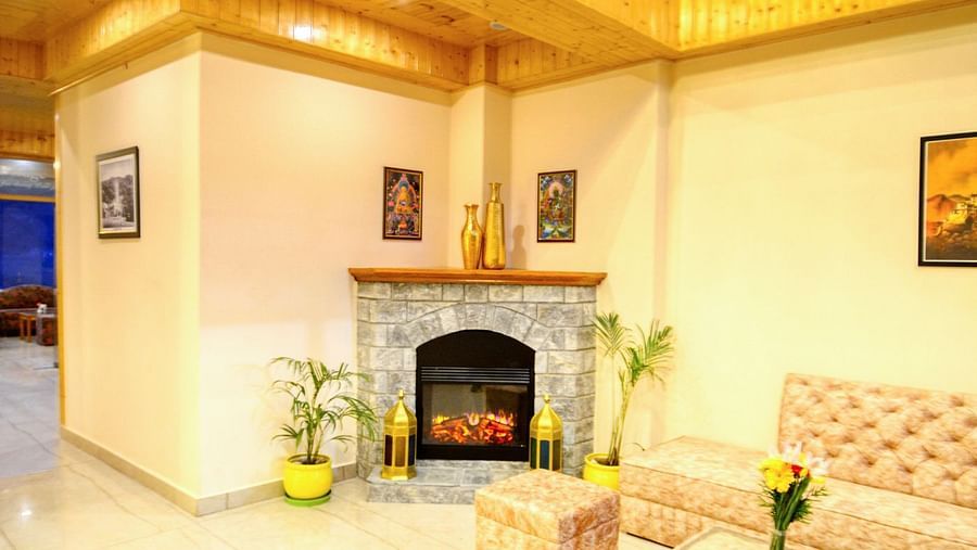 Well lit lobby area with a fireplace - Clarks Inn Suites, Manali