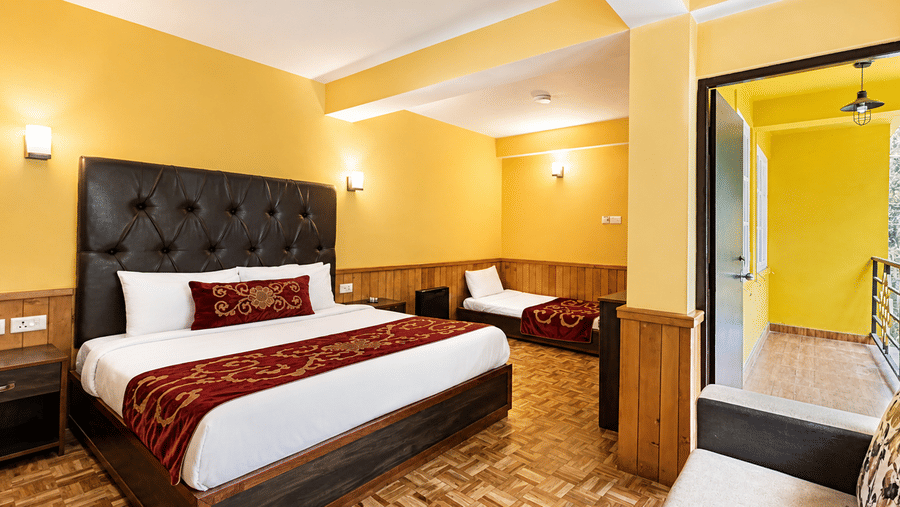Premium Room at Orsino Khangri Karpo Retreat & Spa, Lachung features a large double bed and a smaller single bed. 