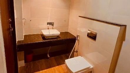 The washroom of the executive room featuring the toilet seat and wash basin - Five Elements Hotels, Haridwar