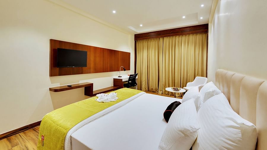 superior room with double bed and a flat screen tv in the front for entertainment options.