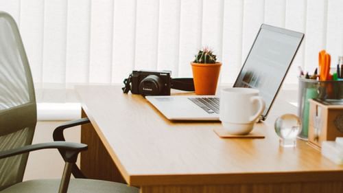 laptop and coffee mug on desk