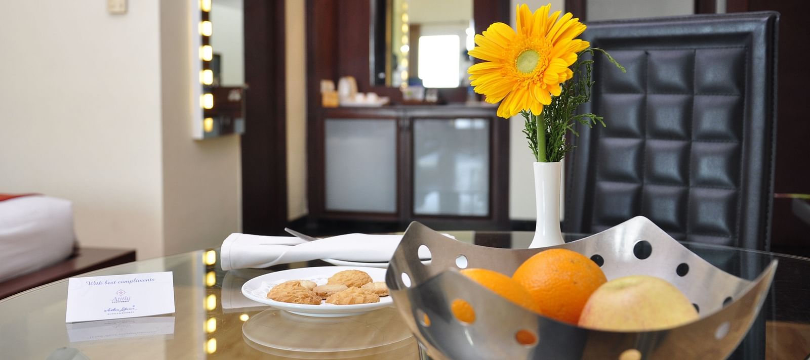 fruits and flower placed on a table at Hotel Atithi - TGI Grand, Pondicherry