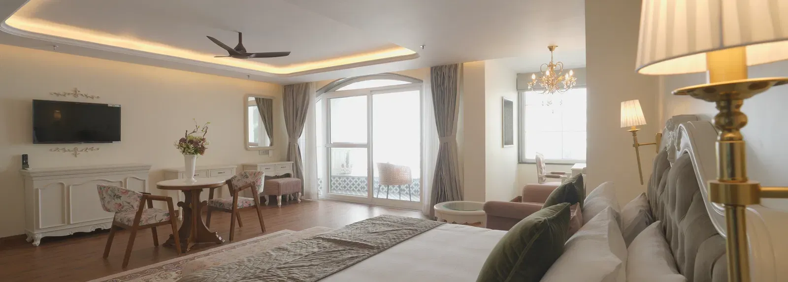 Luxury suite featuring a queen size bed, soft lighting, and refined decor - Mayfair Cafe & Suites, Dalhousie