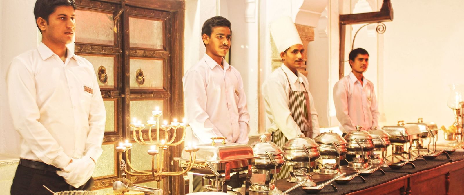 Staff prepare a lavish buffet spread at Fort Barli, showcasing the fort's hospitality and attention to detail.