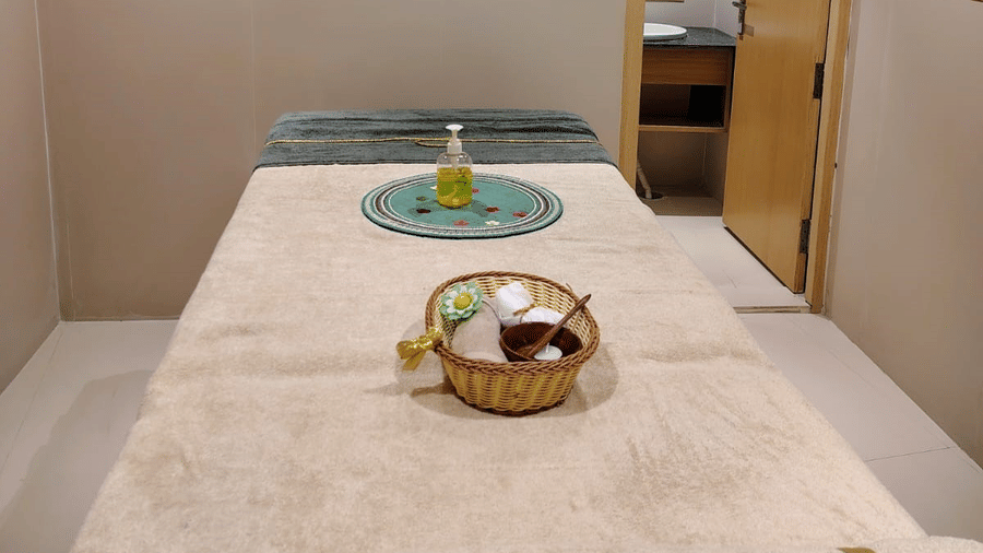 Spa room at ABN Sarovar Portico, Jim Corbett featuring a bed where a basket is kept with spa products.