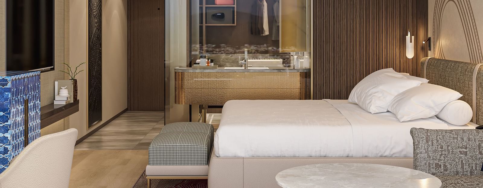 A side view of a double bed room with rug, TV, table, chair and mirror with modern interior at Merlis Hotel, Coimbatore