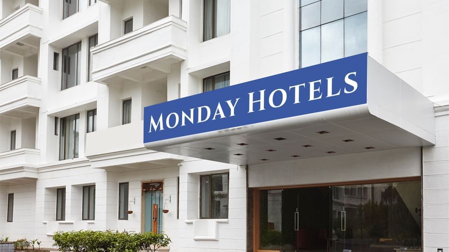 The main entrance of Monday Hotels Mahape, Navi Mumbai, with the hotel's sign visible on the building.
