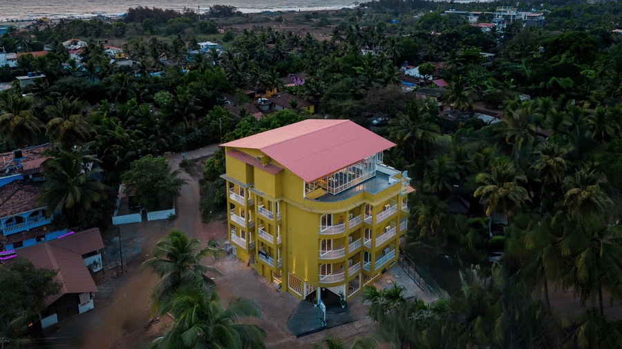 Aerial view of the exterior of Bedzz Xclusive, Morjim, Goa during sunset.