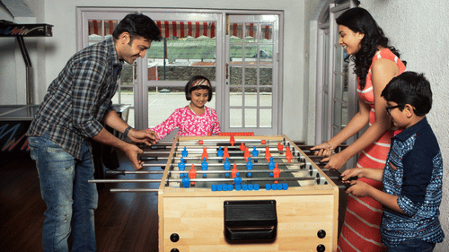 a family playing Foosball 