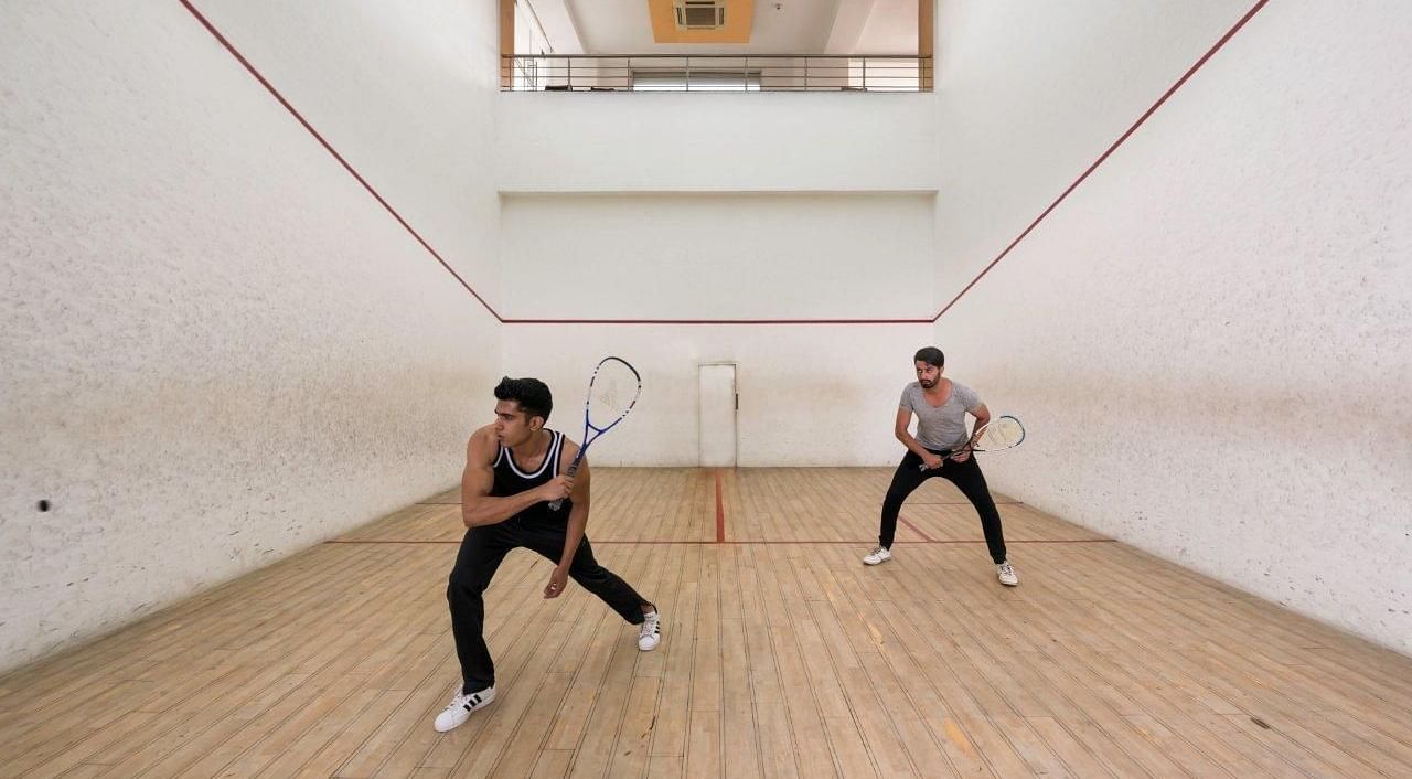 Two men playing Squash at Nirvana Luxury Hotel, Ludhiana.