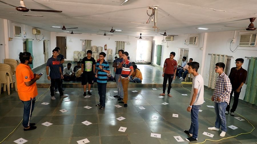 Team Game - Sajan - indoor activity in a room with people standing at equal distances.