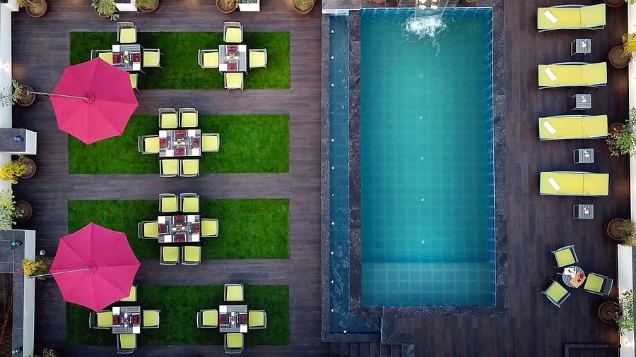 An aerial shot of our swimming pool with sun loungers on the side - Golden Tulip, Agra