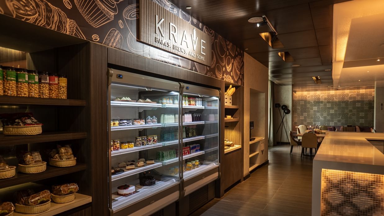 View of the grab-and-go station, showing shelves filled with a variety of snacks, drinks, and fresh food at The Residency Towers Rameswaram.