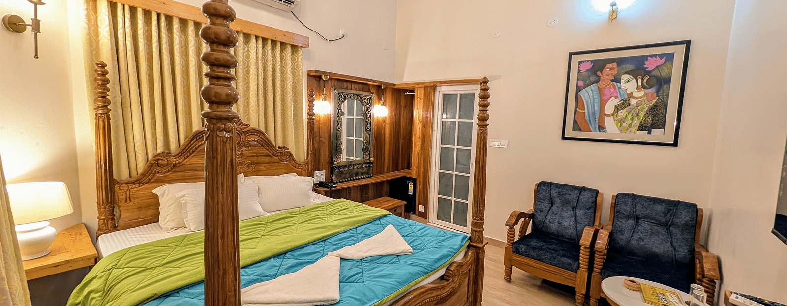 full view image of the pool side cottage featuring a double bed along with cushioned couch in the corner at dip holidays