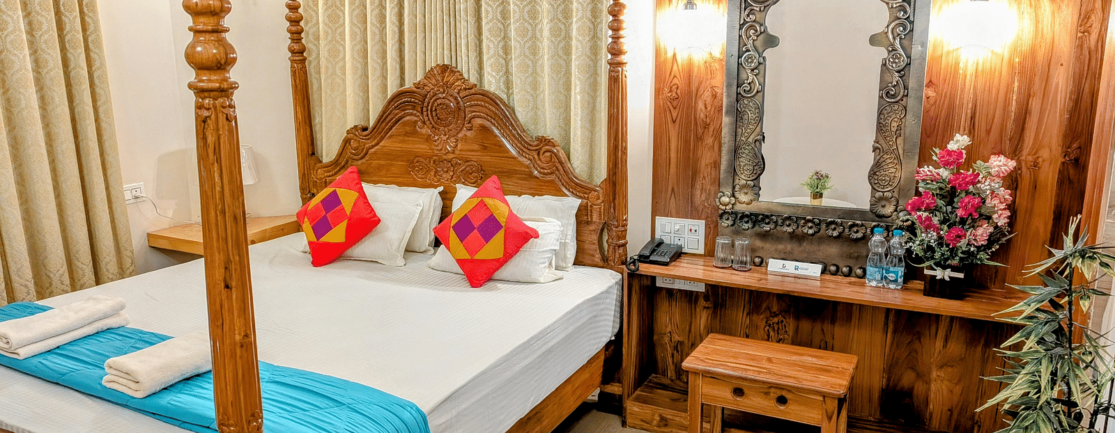 image of a double bed at the pool side cottage at dip holidays along with a dressing table besides it