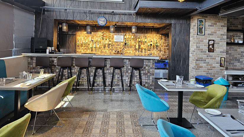 side view of the seating arrangements and a bar counter at Bigg Shots Resto Bar in Quality Inn Rockwell Grand